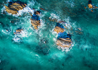 Image showing Beautiful light in ocean surrounding coastal rocks in high tide