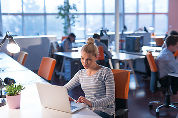 Image showing businesswoman using a laptop in startup office