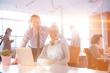 Image showing Young businessman helping his colleague at the work