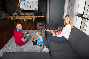 Image showing Happy family playing a hockey video game