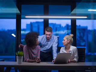 Image showing Multiethnic startup business team in night office