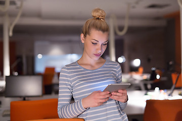 Image showing woman working on digital tablet in night office