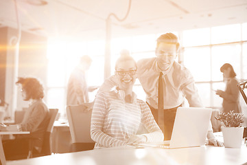 Image showing Young businessman helping his colleague at the work