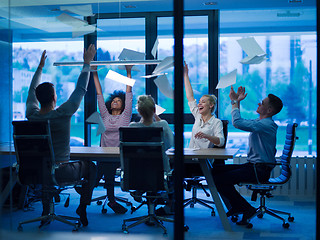 Image showing multiethnic Group of young business people throwing documents