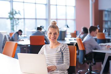 Image showing businesswoman using a laptop in startup office