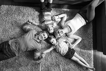 Image showing happy family lying on the floor