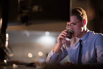 Image showing Tired businessman working late