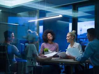 Image showing Multiethnic startup business team in night office