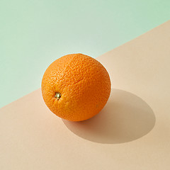 Image showing fresh orange on colored paper background