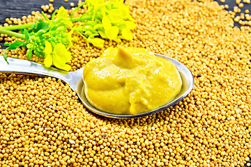 Image showing Sauce mustard in spoon with flower on seeds