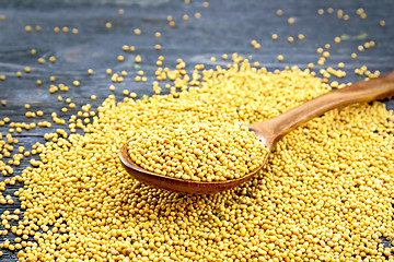 Image showing Mustard seeds in spoon on black board