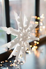 Image showing paper snowflake decoration hanging on window