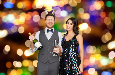 Image showing couple with champagne bottle at christmas party