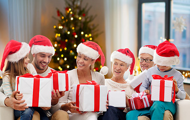 Image showing happy family with christmas gifts at home