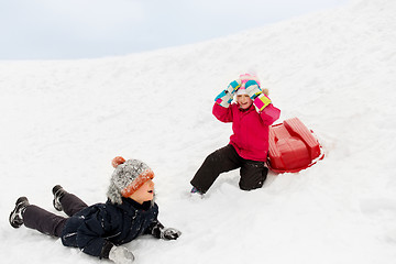 Image showing happy little kids with sled down hill in winter