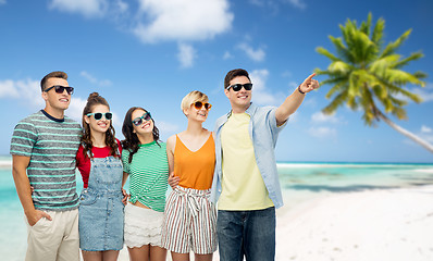 Image showing friends in sunglasses over tropical beach