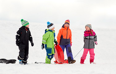 Image showing happy little kids with sleds sledging in winter