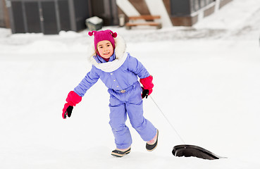 Image showing little girl with sleds on snow hill in winter