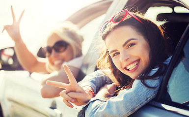 Image showing happy teenage girls or women in car at seaside