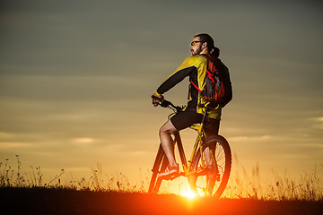 Image showing Man in helmet and glasses stay on the bicycle