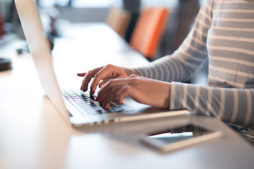 Image showing businesswoman using a laptop in startup office