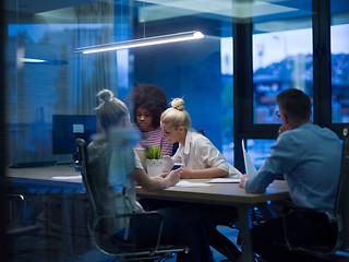 Image showing Multiethnic startup business team in night office