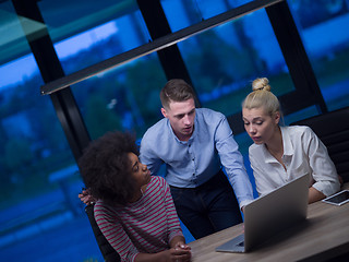 Image showing Multiethnic startup business team in night office