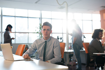 Image showing businessman working using a laptop in startup office