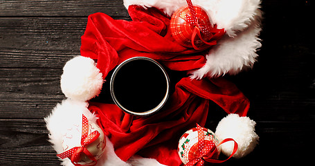 Image showing Cup of coffee with Christmas hats around 