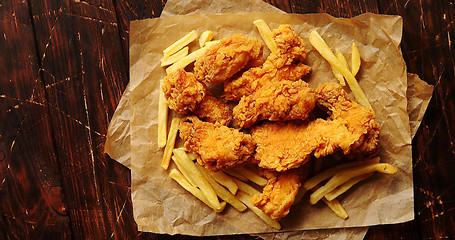 Image showing Fried meat and potatoes on paper