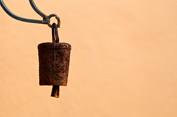 Image showing old rusty bell hanging against blank wall