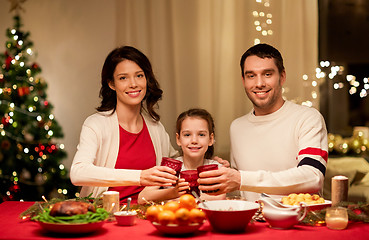 Image showing happy family having christmas dinner at home