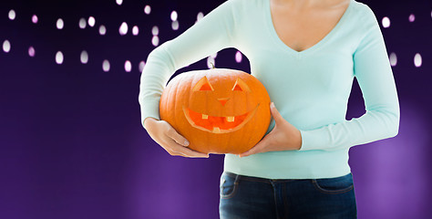 Image showing close up of woman holding halloween pumpkin