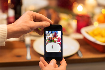 Image showing hands photographing food at christmas dinner