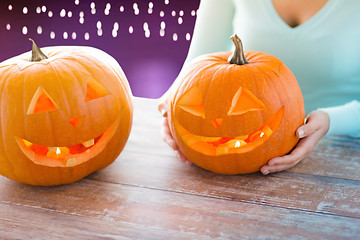 Image showing close up of woman with halloween pumpkins