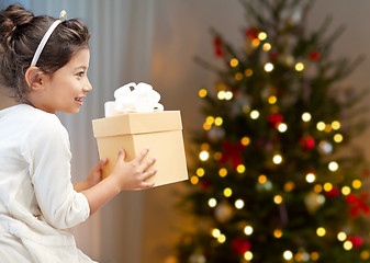 Image showing happy little girl with christmas gift at home