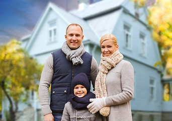 Image showing happy family over living house in autumn