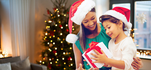 Image showing happy mother and daughter with christmas gift