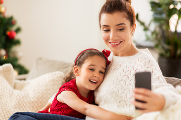 Image showing family taking selfie by smartphone at home