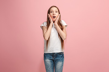 Image showing Beautiful teen girl looking suprised isolated on pink