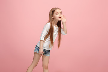 Image showing Isolated on pink young casual teen girl shouting at studio