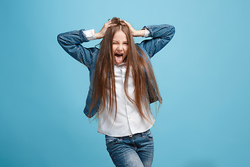 Image showing The squint eyed teen girl with weird expression isolated on blue