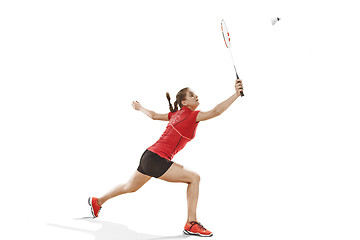 Image showing Young woman playing badminton over white background