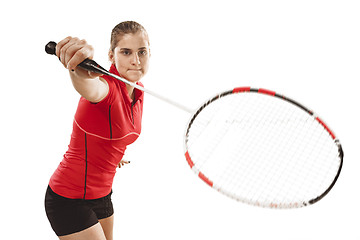 Image showing Young woman playing badminton over white background