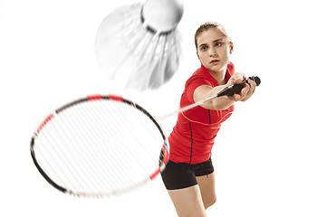 Image showing Young woman playing badminton over white background