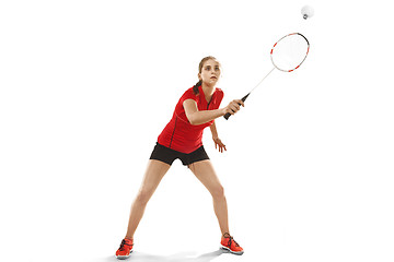 Image showing Young woman playing badminton over white background