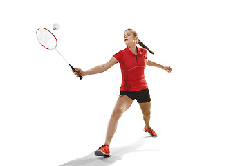 Image showing Young woman playing badminton over white background