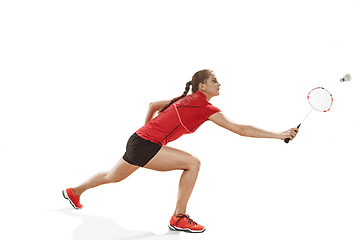 Image showing Young woman playing badminton over white background