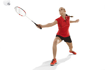 Image showing Young woman playing badminton over white background