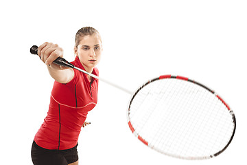 Image showing Young woman playing badminton over white background